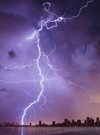 A bolt of lightning cracking down from a violet sky.